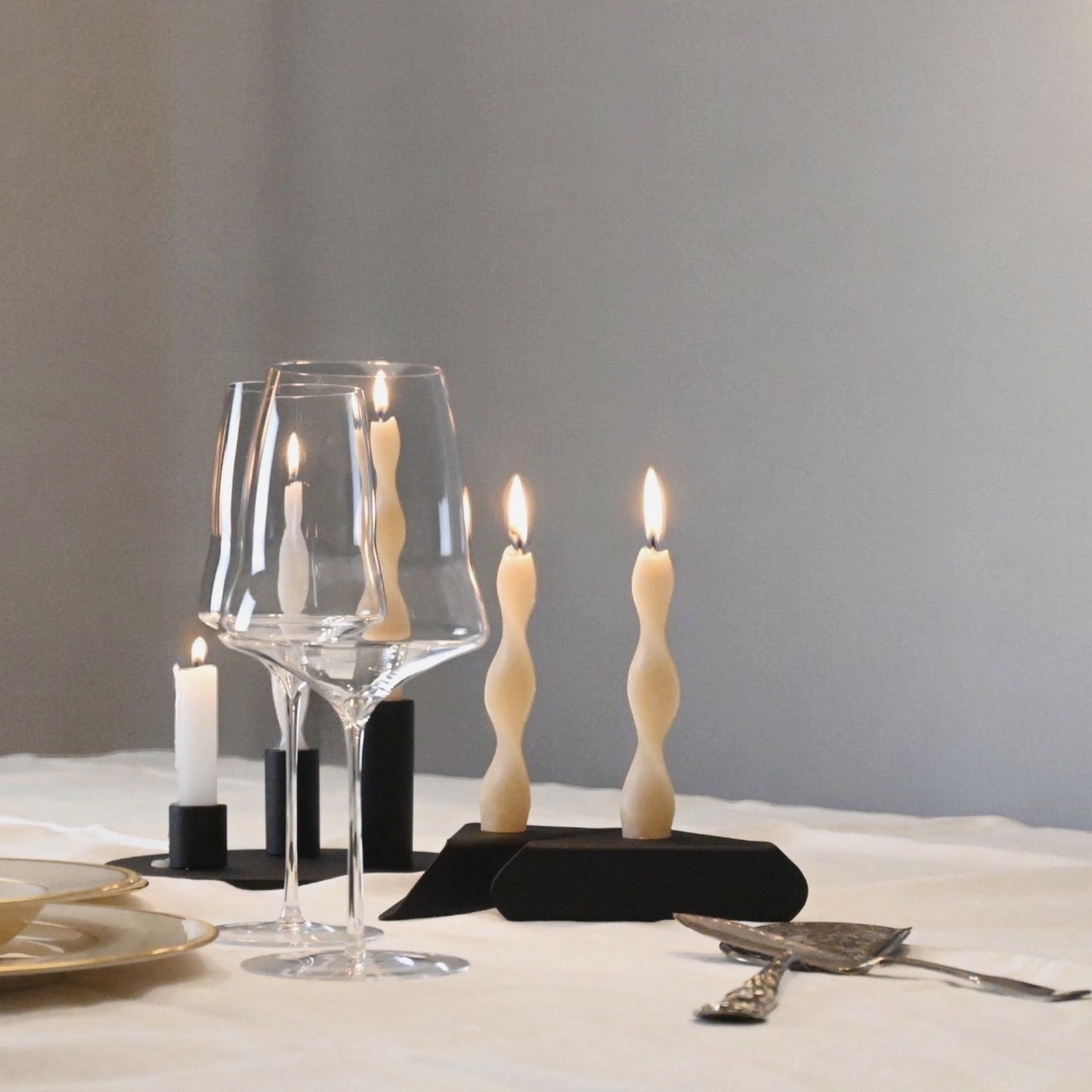 Soporte Costur lacado en negro texturado, con dos velas helicoidales de color crema